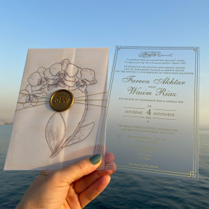 Frosted acrylic wedding invitation. Printed parchment wrapping. Wax seal. Rose gold foil printing 