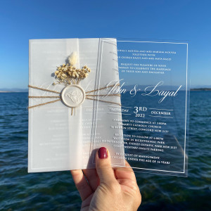 White Printed Clear Acrylic Wedding Invitation. Parchment Wrapping. White wax seal and dired flowers