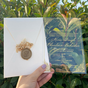 Acrylic Indian wedding invitation. Clear acrylic wedding invitation. Ivory envelope. Gold foil print. Wax seal and dried flowers.